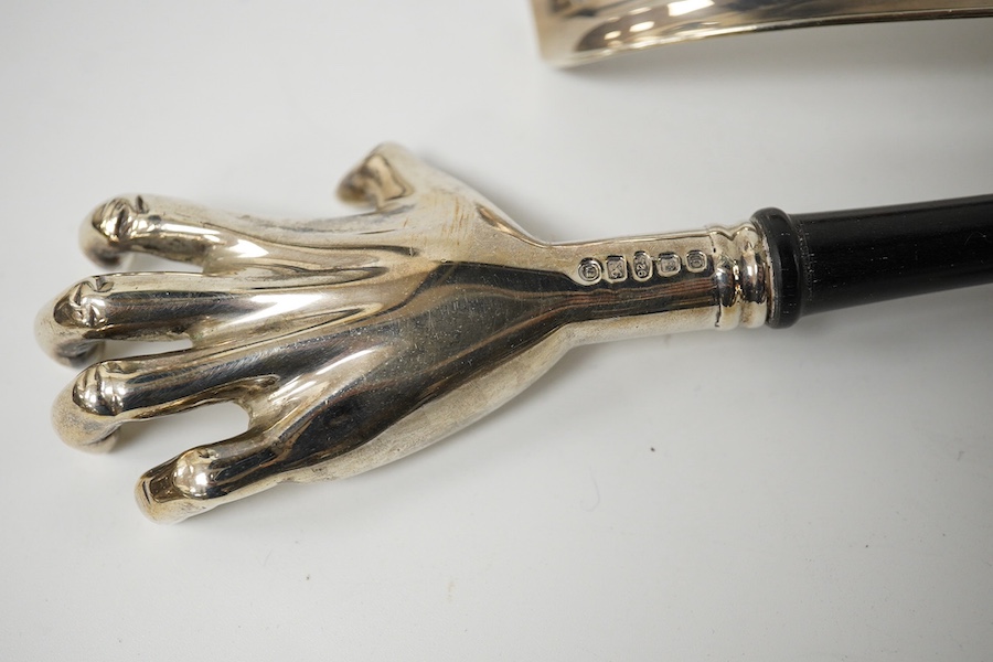 A modern novelty ebony handled silver back scratcher, 	Francis Howard Ltd, London, 2008, 38.6cm, a modern silver novelty duck’s head combination paperclip/match strike, London, 1905 and a silver shoe-horn. Condition - fa